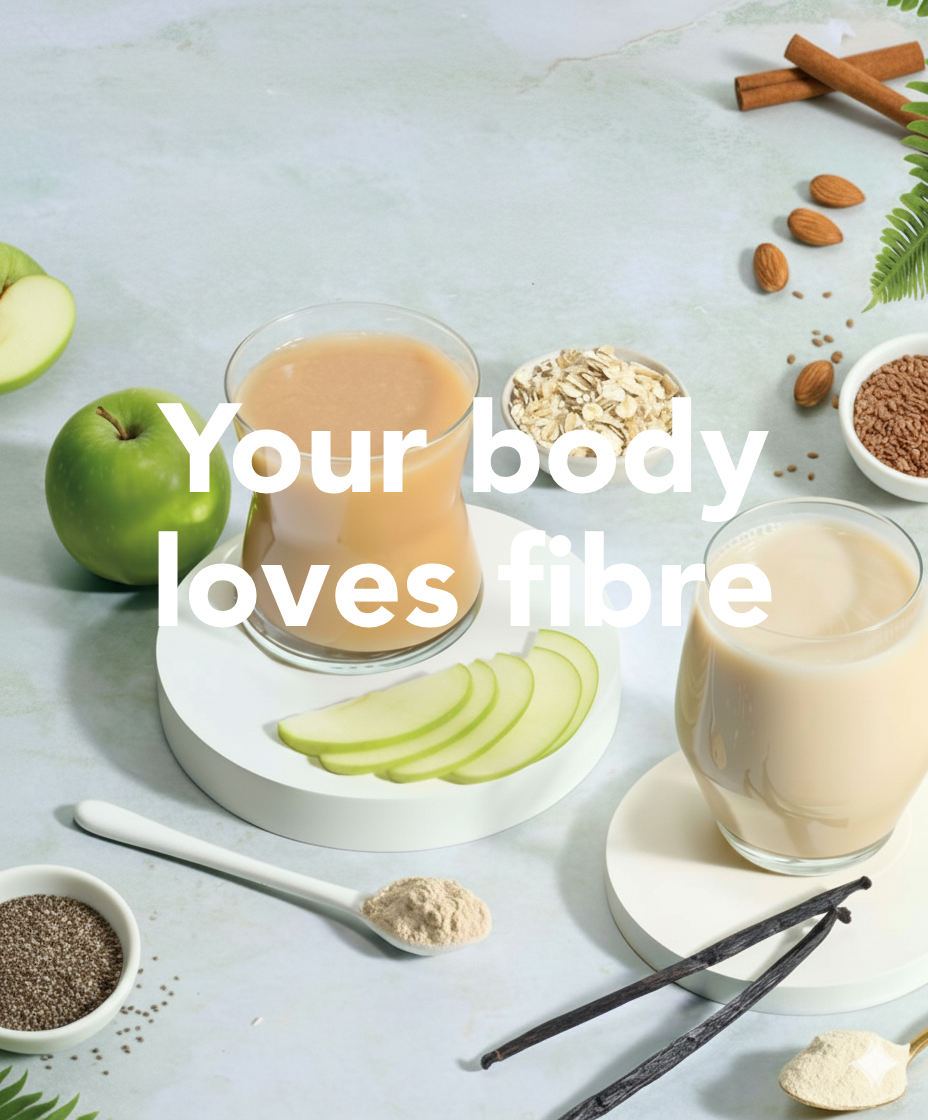 Two glasses of a creamy beverage with apples, oats, and vanilla beans on a light surface.
