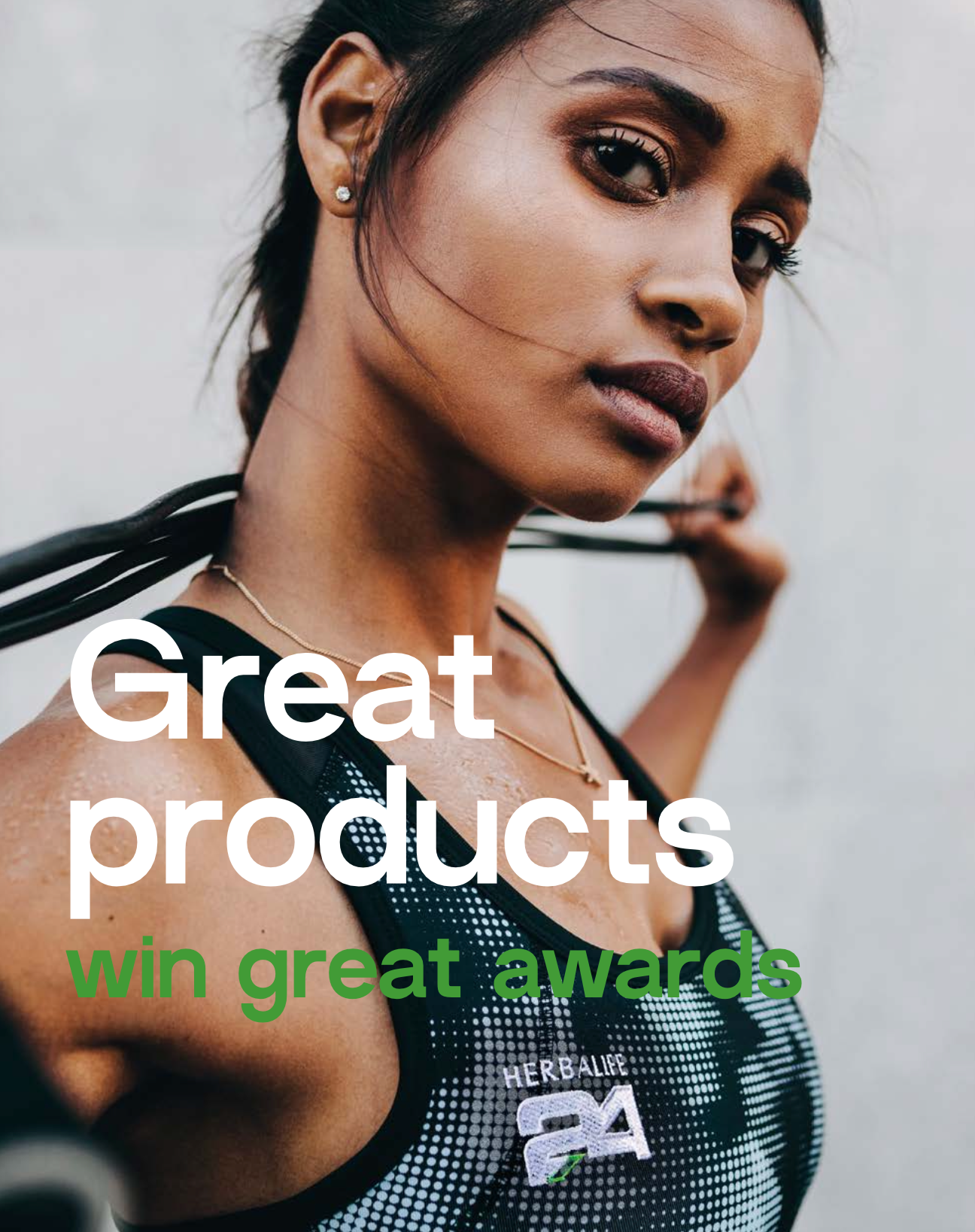 Woman in athletic wear with text 'Great products win great awards' and a brand logo.